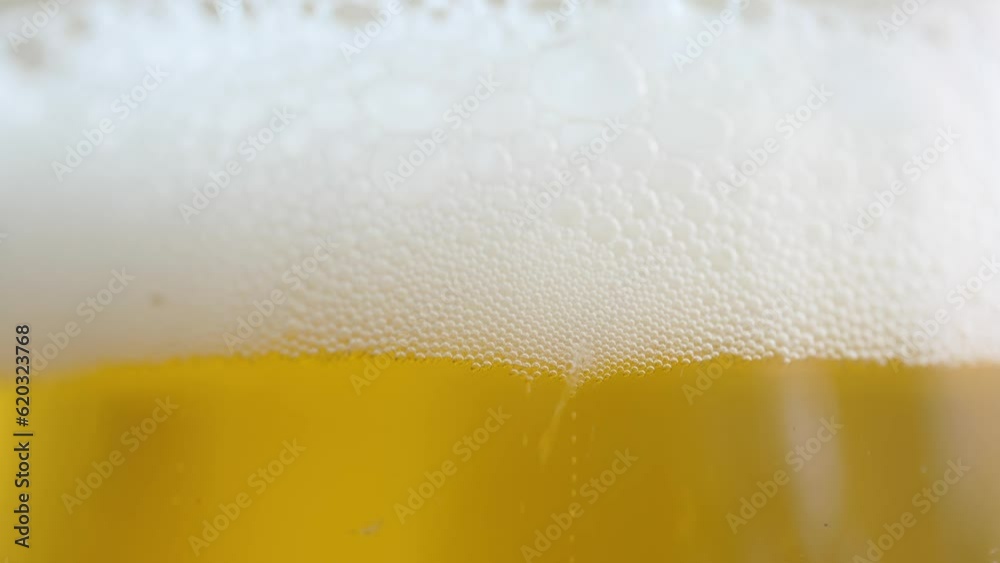 close-up. Air bubbles rise up from the bottom of the glass of beer. close-up. Air bubbles rise up from the bottom of the glass of beer.