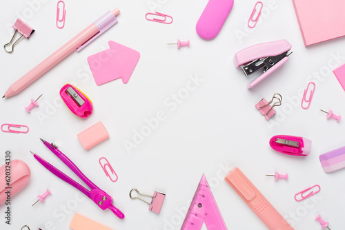 Pink school stationery on color backgroung, top view