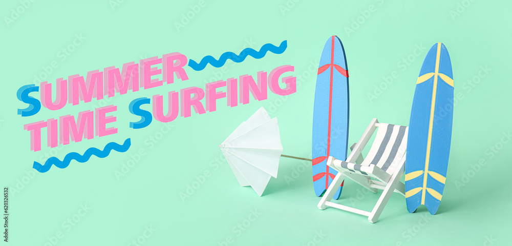 Small surfboards, umbrella and deck chair on turquoise background. Summer time Small surfboards, umbrella and deck chair on turquoise background. Summer time