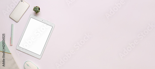 Modern tablet computer with mobile phone and office stationery on light background with space for text