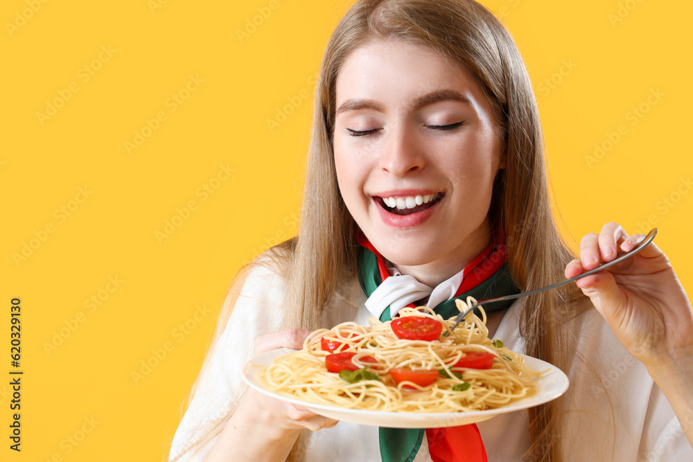Young woman with tasty pasta on yellow background, closeup Young woman with tasty pasta on yellow background, closeup