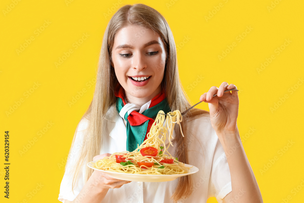 Young woman with tasty pasta on yellow background, closeup Young woman with tasty pasta on yellow background, closeup