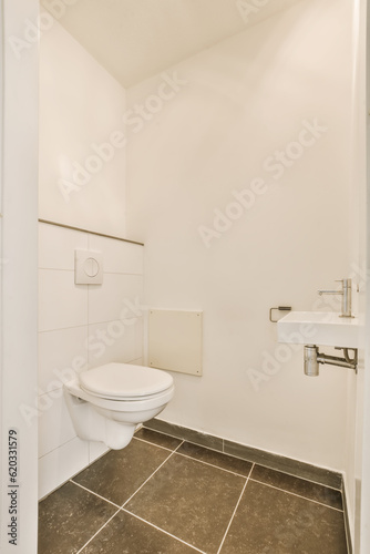 a white bathroom with tile flooring and wall mounted toilet in the corner, there is a mirror on the wall