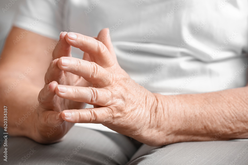Hands of senior woman sitting at home, closeup Hands of senior woman sitting at home, closeup