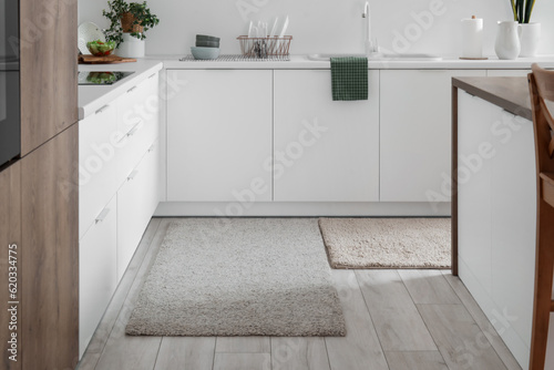 Soft rugs in interior of modern kitchen