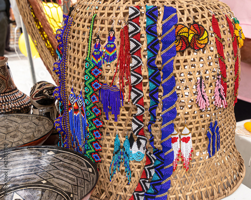 Various crafts of Quechua women from the Ecuadorian Amazon region, Puyo city. Ceramics with traditional painting, natural fiber basket, beaded earrings, bracelets and necklaces
