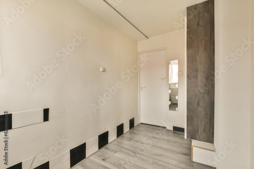 an empty room with white walls and black trim around the door to the right is a mirror on the wall