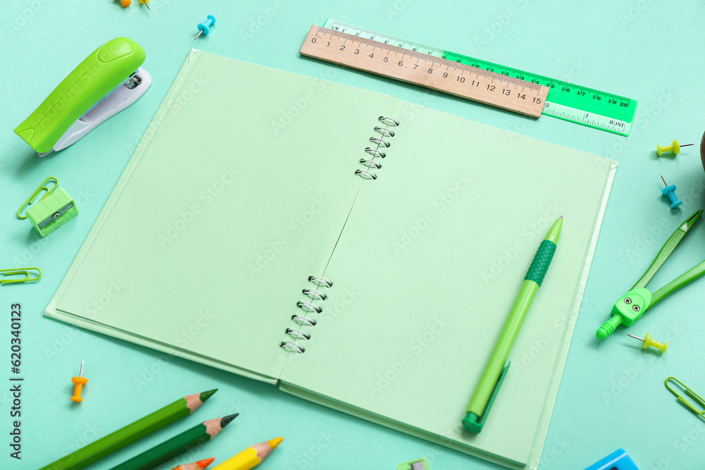Blank notebook and different stationery on turquoise background Blank notebook and different stationery on turquoise background