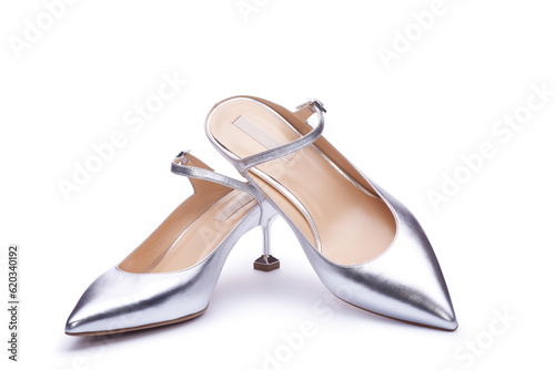 A pair of feminine silver metallic shoes with creative design heel and pointed toe. Close up view, isolated on the white background. Concept for A modern and fashionable shoe store.