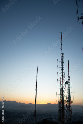 фотографія radio and television telecommunication antenna towers with parabolic sunset or s