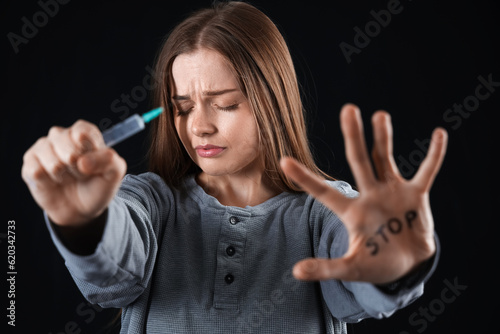 Young female junkie with sy...