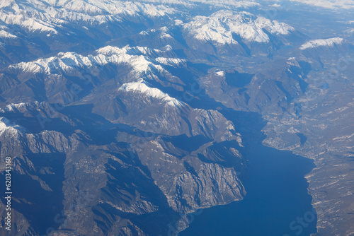 Lake Como Italy view from above . Aerial view of the Alps range from the airplane window