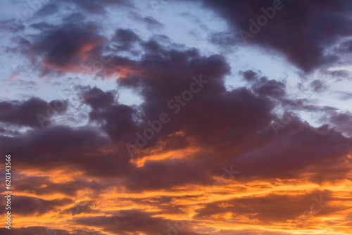 Real amazing sunrise or sunset sky with gentle colorful clouds