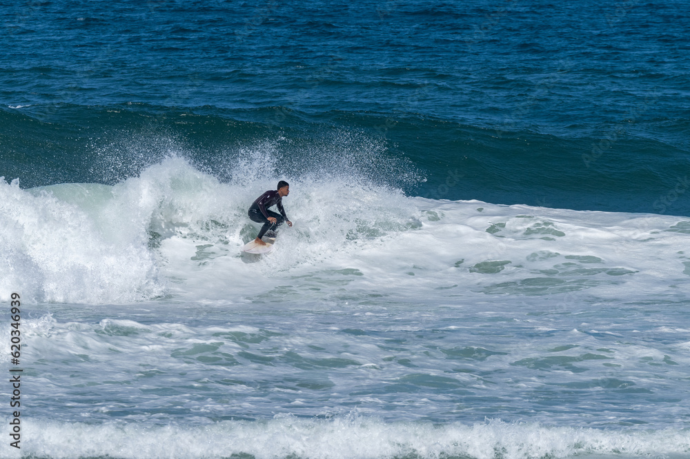 Surfer riding waves in Furadouro Beach Surfer riding waves in Furadouro Beach