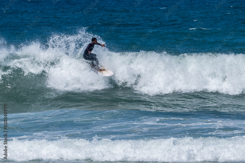 Surfer riding waves in Furadouro Beach