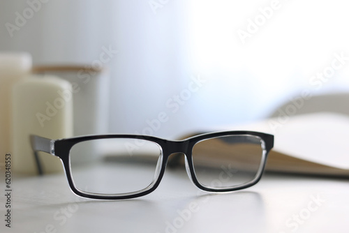 glasses for vision correction on a table in the interior of the room 