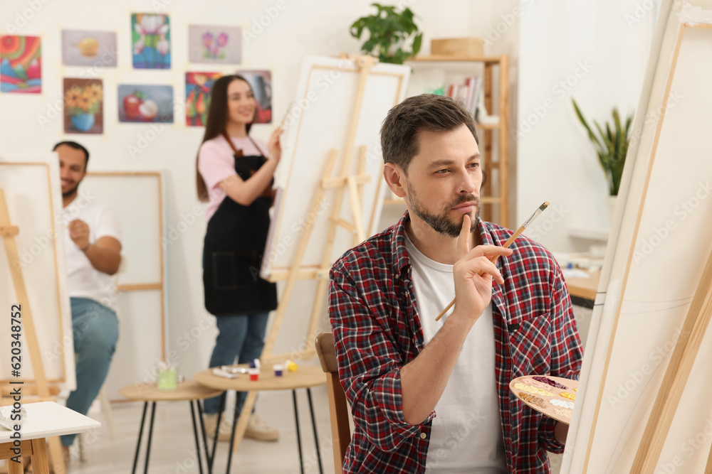 Group of students attending painting class in studio. Creative hobby Group of students attending painting class in studio. Creative hobby
