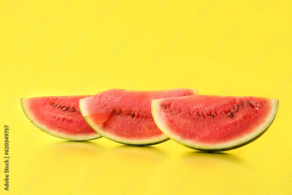 Pieces of fresh watermelon on yellow background Pieces of fresh watermelon on yellow background