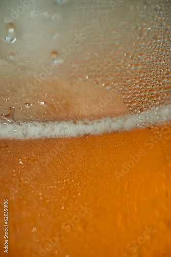 beer in a close-up macro photo, showcasing its golden hue, frothy foam, and enticing details. Raise your glass and immerse yourself in the intoxicating beauty of this refreshing beverage.