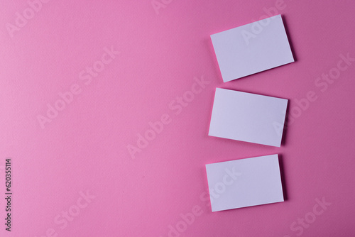 White business cards with copy space on pink background