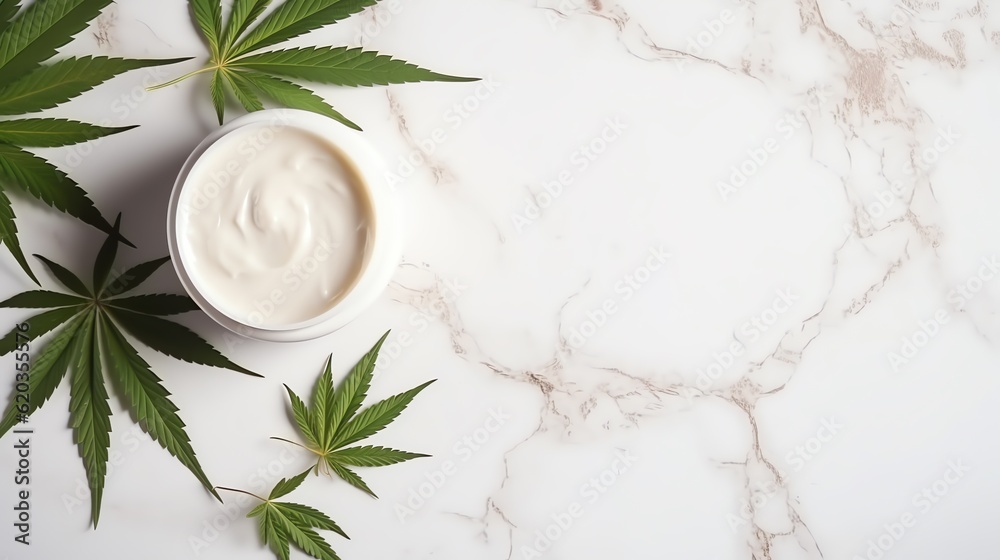 Jar of cbd cream with cannabis marijuana leaves sitting on top of a marble white table. Space for text. Jar of cbd cream with cannabis marijuana leaves sitting on top of a marble white table. Space for text.