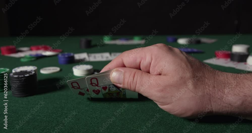 Poker Player Considers His Move with two Queens Poker Player Considers His Move with two Queens