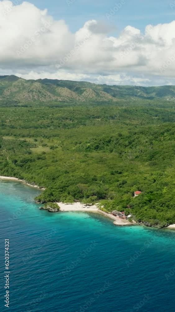 Coast with a shiny white beach under clear blue sky. Fly above a paradise Island. Siquijor, Philippines. Coast with a shiny white beach under clear blue sky. Fly above a paradise Island. Siquijor, Philippines.
