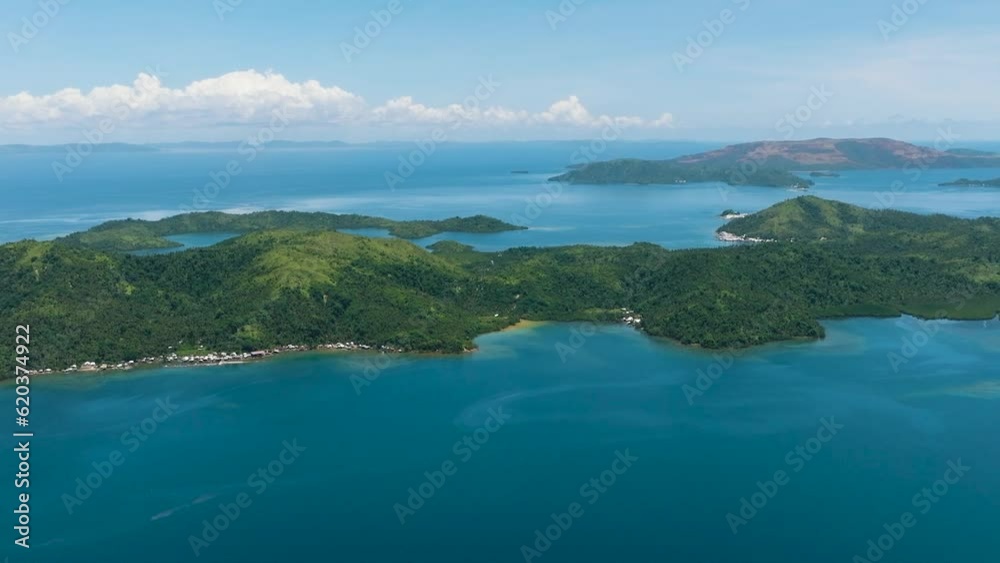 View from above of the coastline of house in tropical island. Blue water and sky landscape, travel concept. Mindanao, Philippines. View from above of the coastline of house in tropical island. Blue water and sky landscape, travel concept. Mindanao, Philippines.