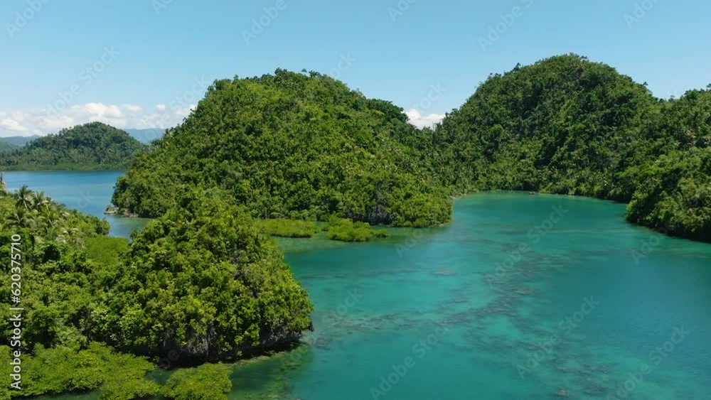 Aerial view of beautiful turquoise water in lagoons. Blue skies and clear clouds. Tinago Island. Mindanao, Philippines. Aerial view of beautiful turquoise water in lagoons. Blue skies and clear clouds. Tinago Island. Mindanao, Philippines.