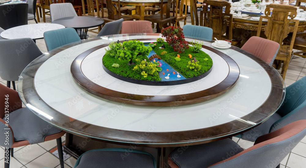 Fototapeta premium Chinese dining table, a round dining table with plant scenery.