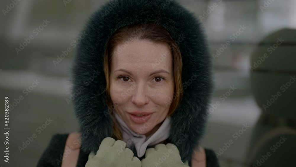 charming middle-aged woman in warm coat with hood looking at camera, close up portrait, better aging charming middle-aged woman in warm coat with hood looking at camera, close up portrait, better aging