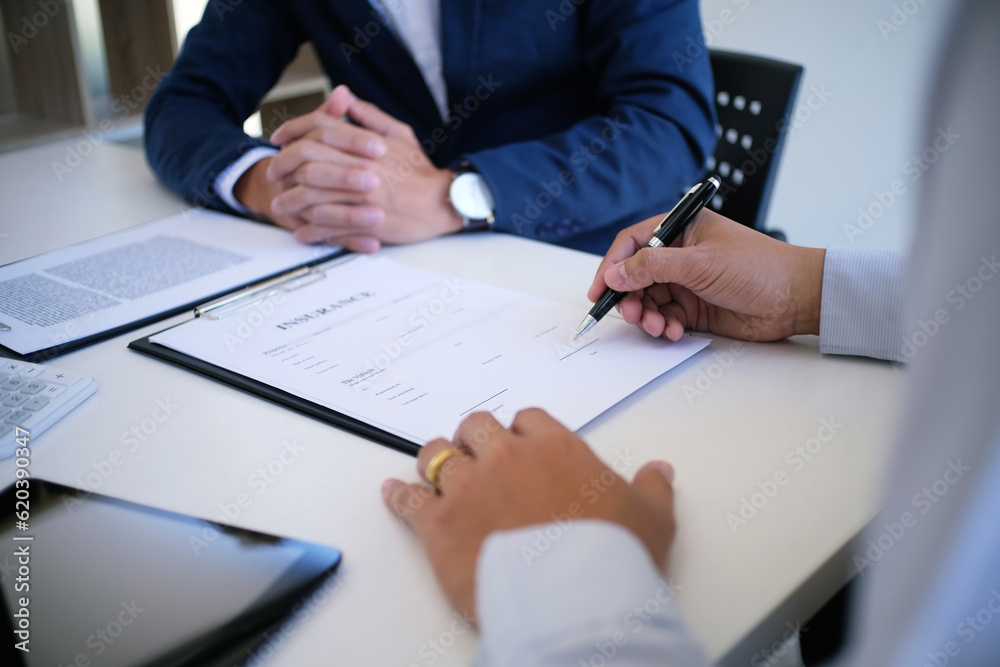 Sales manager giving advice application form document, considering mortgage loan offer for car and house insurance. Sales manager giving advice application form document, considering mortgage loan offer for car and house insurance.