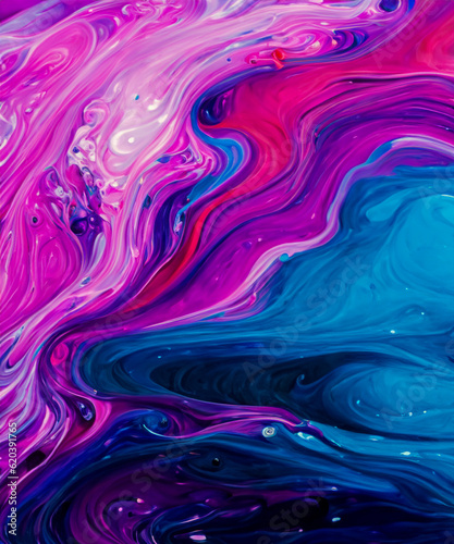 Beautiful abstraction of liquid paints in slow blending flow mixing together gently © squallice