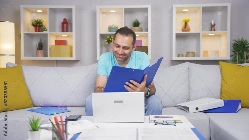 Home office worker man looking at paperwork files. Home office worker man looking at paperwork files.