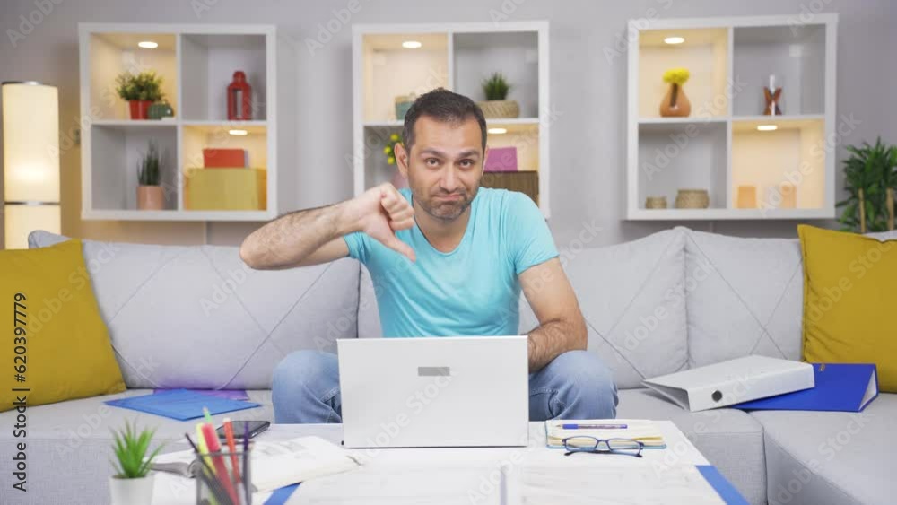 Home office worker man making negative gesture at camera. Home office worker man making negative gesture at camera.