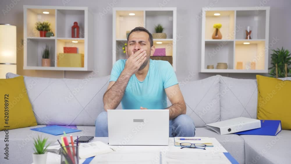Home office worker man yawns and relaxes at the camera. Home office worker man yawns and relaxes at the camera.