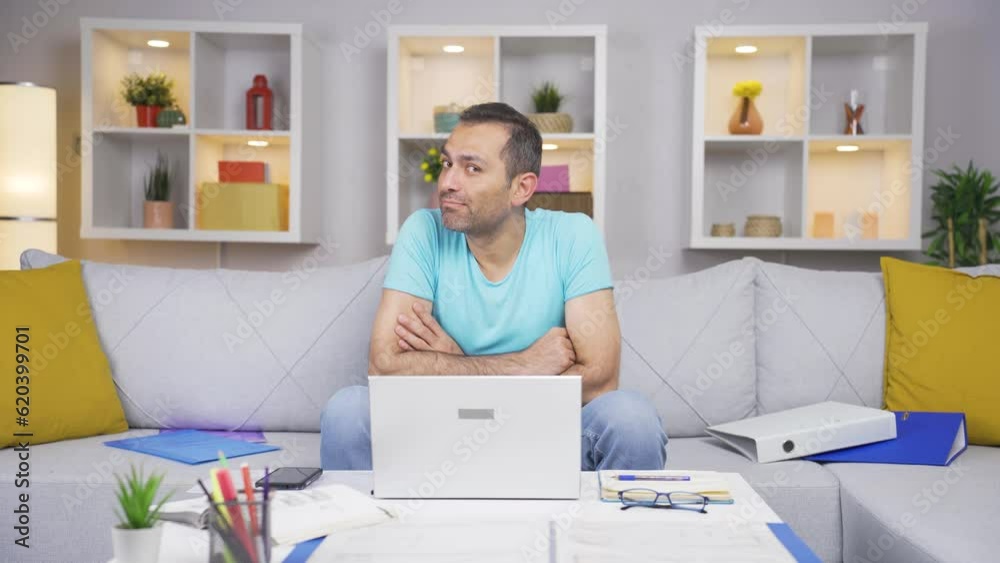 The man working from home gets angry, feels offended and sad.