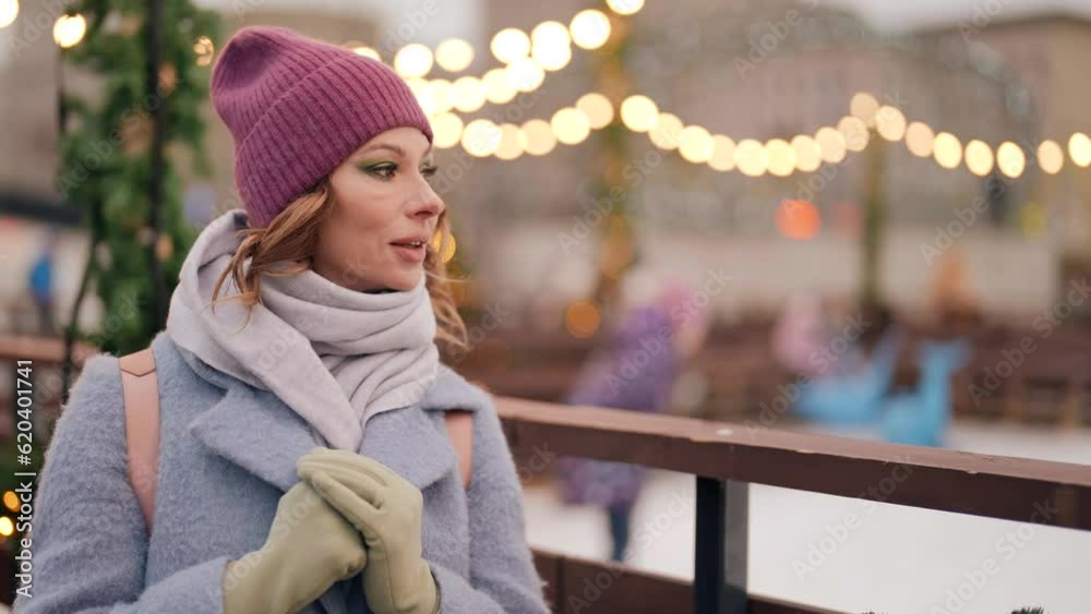 medium portrait of charming middle-aged woman in city in Christmas, beautiful lady smiling medium portrait of charming middle-aged woman in city in Christmas, beautiful lady smiling