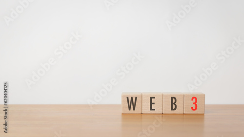Wood cube block with web3 put on wooden table in white background. Web 3.0 technology, decentralized, AI Chat bot, digital security and encryption concept.