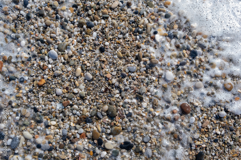 Crushed stone on the seashore. Selective focus on object. The stones were laid on the ground in the garden as a background. Background blur. Pebble stones background. Crushed stone on the seashore. Selective focus on object. The stones were laid on the ground in the garden as a background. Background blur. Pebble stones background.