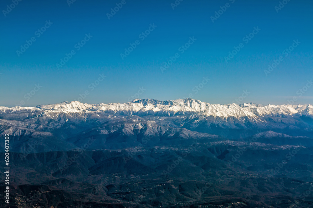 Panorama of high mountain peaks covered with snow on a clear day Panorama of high mountain peaks covered with snow on a clear day