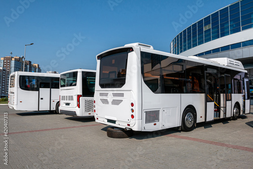 White city buses at the bus station on a clear day