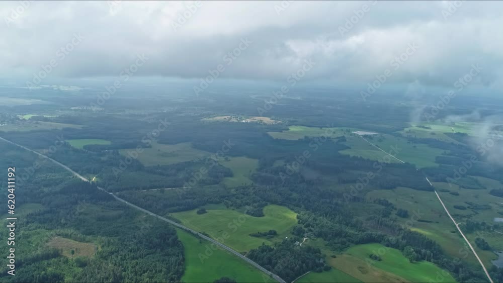 High aerial panoramic view among the clouds on a green landscape. High aerial panoramic view among the clouds on a green landscape.