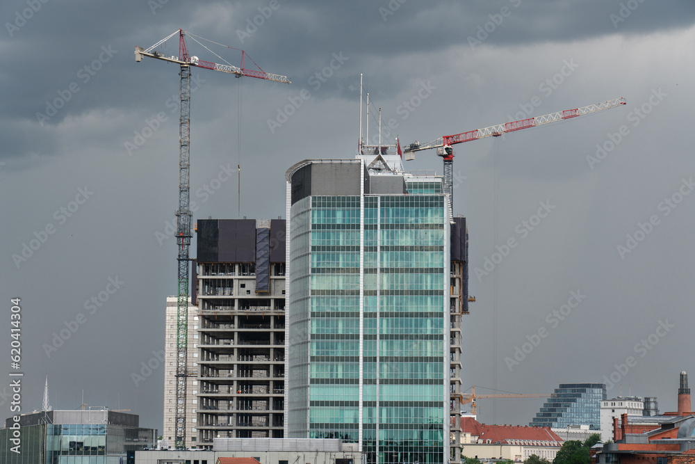 View of the city buildings under construction with cranes. Cityscape. Andersia Poznań