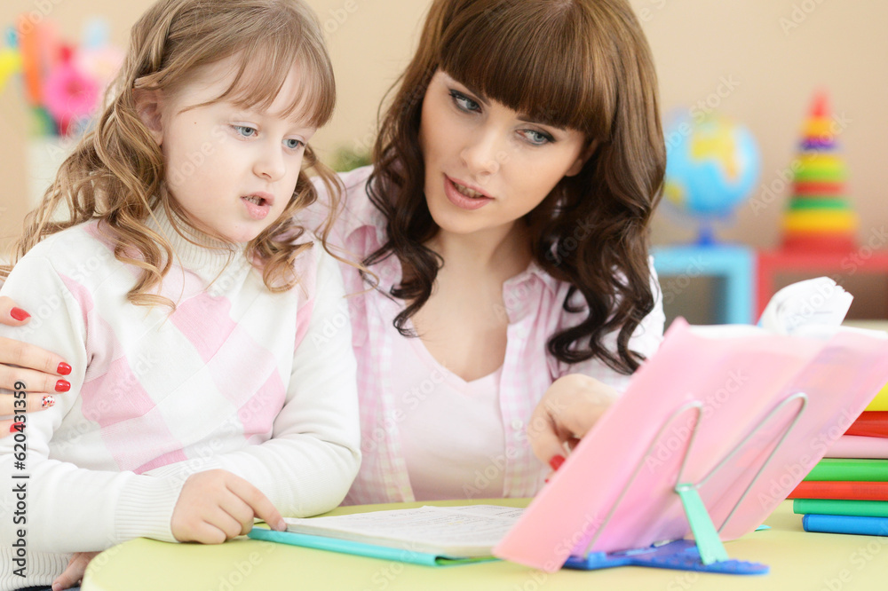 mother with daughter doing homework