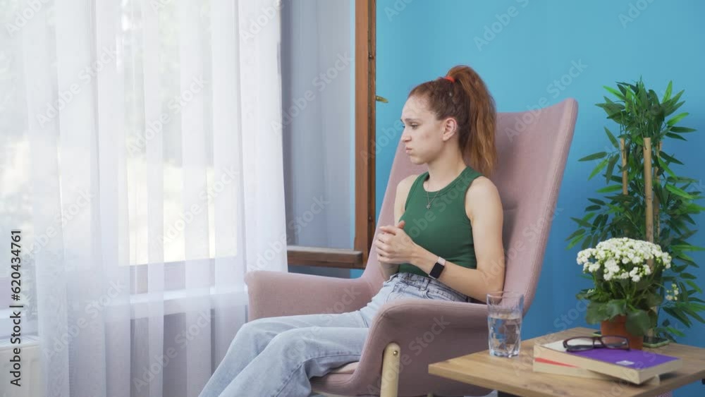 Worried and nervous woman at home watching outside. Worried and nervous woman at home watching outside.