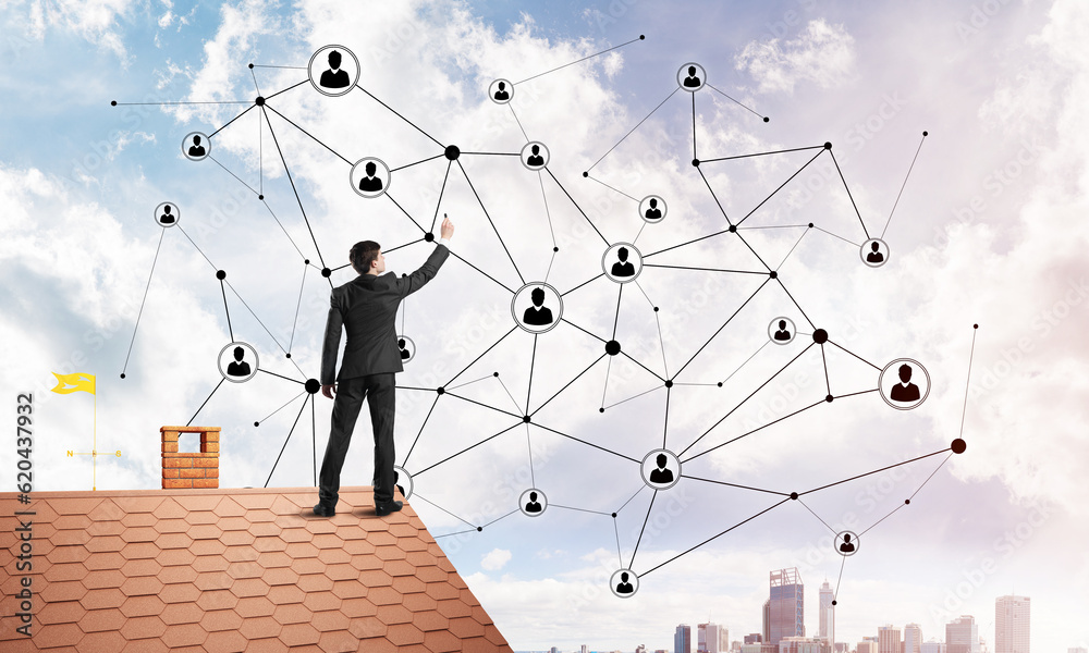 Businessman on house roof presenting networking and connection concept. Mixed media Businessman on house roof presenting networking and connection concept. Mixed media