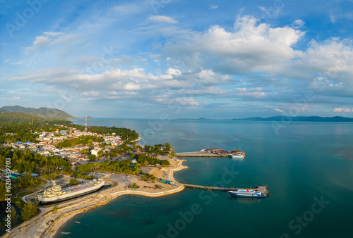 Ko Pha Ngan, Thailand: Aerial panorama of the Thong Sala ferry harbor and town in the Ko Phangan island in the gulf of Thailand with Ko Samui in the background.