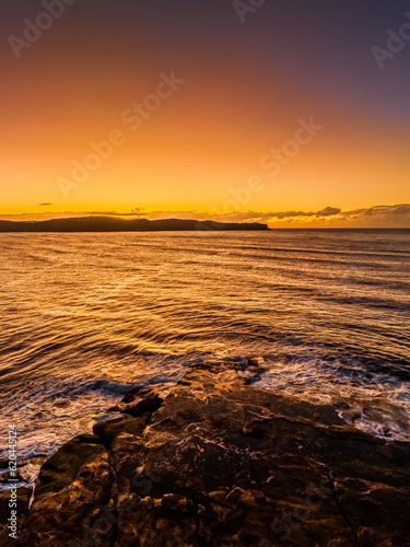 Aerial sunrise over the sea from the headland