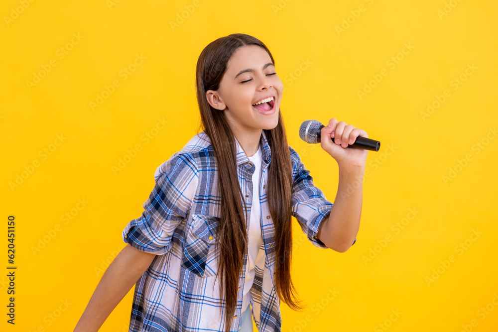happy young girl singer perform karaoke isolated on yellow background. With microphone in hand teenage girl singer. young karaoke singer girl hold microphone. teen girl singer hold mic in studio happy young girl singer perform karaoke isolated on yellow background. With microphone in hand teenage girl singer. young karaoke singer girl hold microphone. teen girl singer hold mic in studio